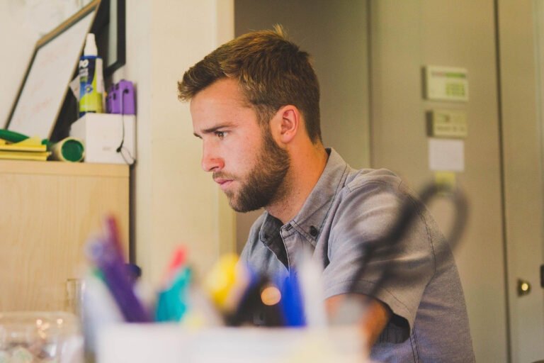 person speaking to smart assistant at desk